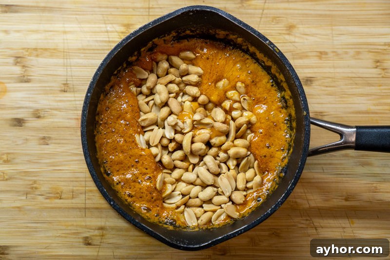 Adding the peanuts to the caramel