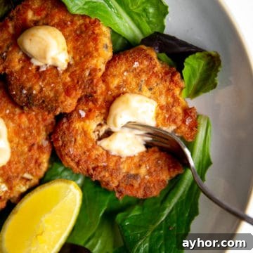 Paleo salmon cakes on a bed of salad greens.