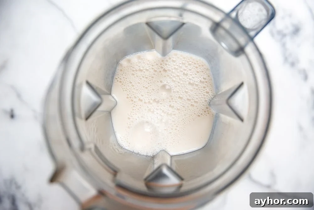 Low-Sugar Green Smoothie Recipe That Actually Tastes Great 5 Almond milk in a blender container.
