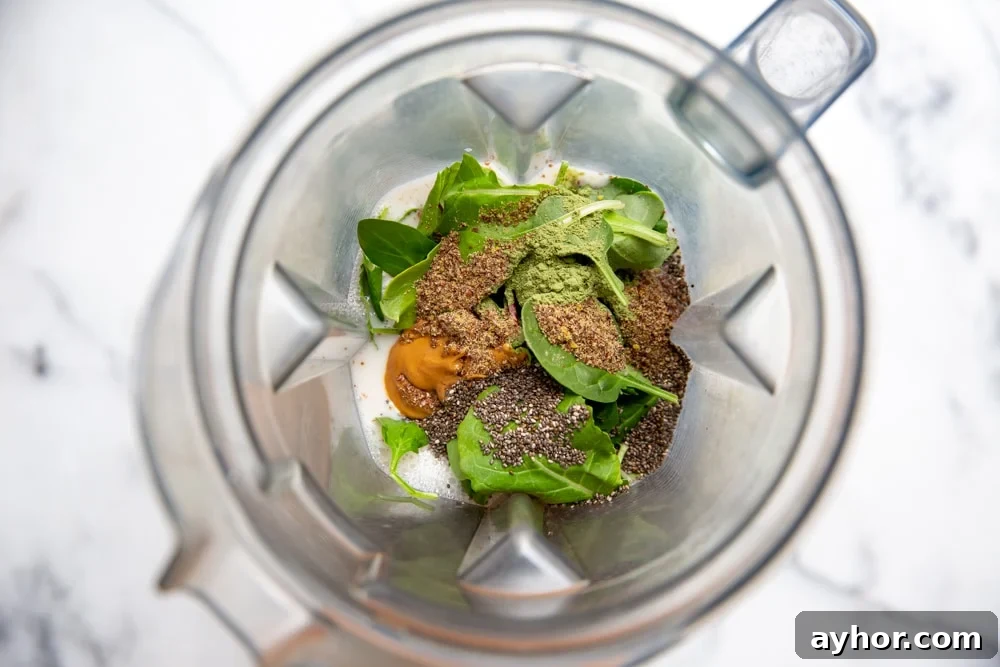 Low-Sugar Green Smoothie Recipe That Actually Tastes Great 6 Process shot showing all of the smoothie ingredients in a blender container.