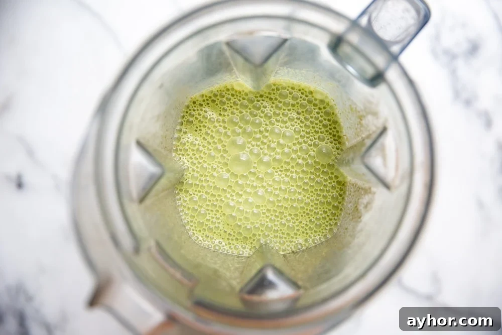Low-Sugar Green Smoothie Recipe That Actually Tastes Great 7 Overhead shot of the low sugar green smoothie in a blender.