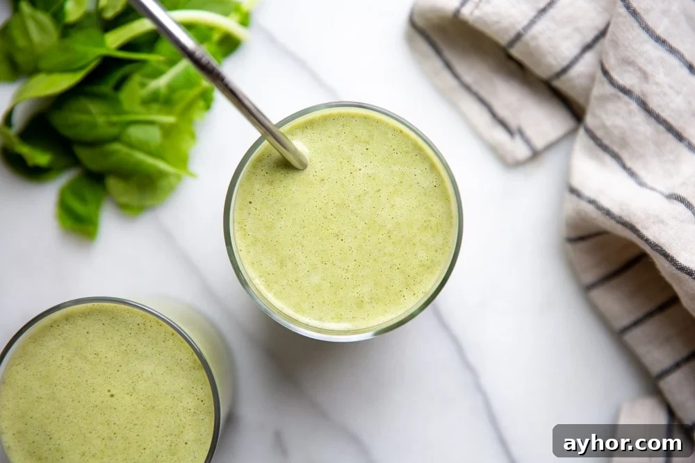Low-Sugar Green Smoothie Recipe That Actually Tastes Great 8 Two low sugar green smoothies in glasses on a marble surface.
