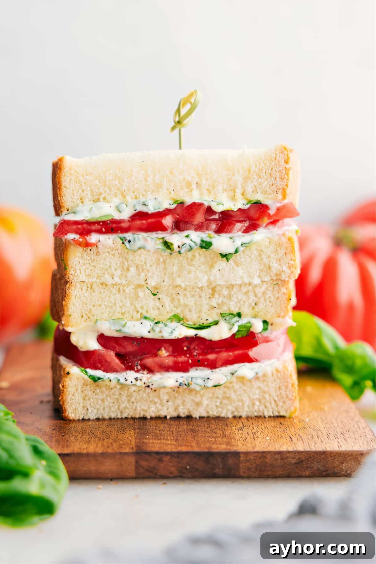 The Best Tomato Sandwich Recipe Tomato Sandwich stacked on top of each other showing the delicious inside.