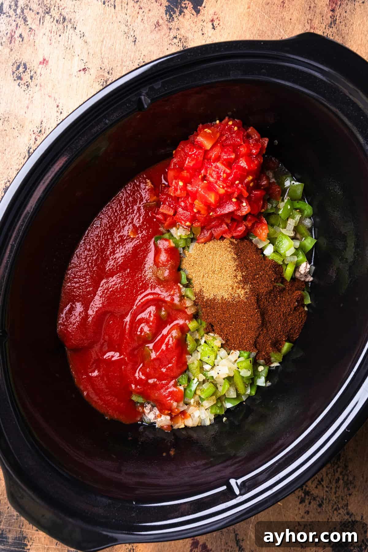 All ingredients added to a crockpot to make chili.