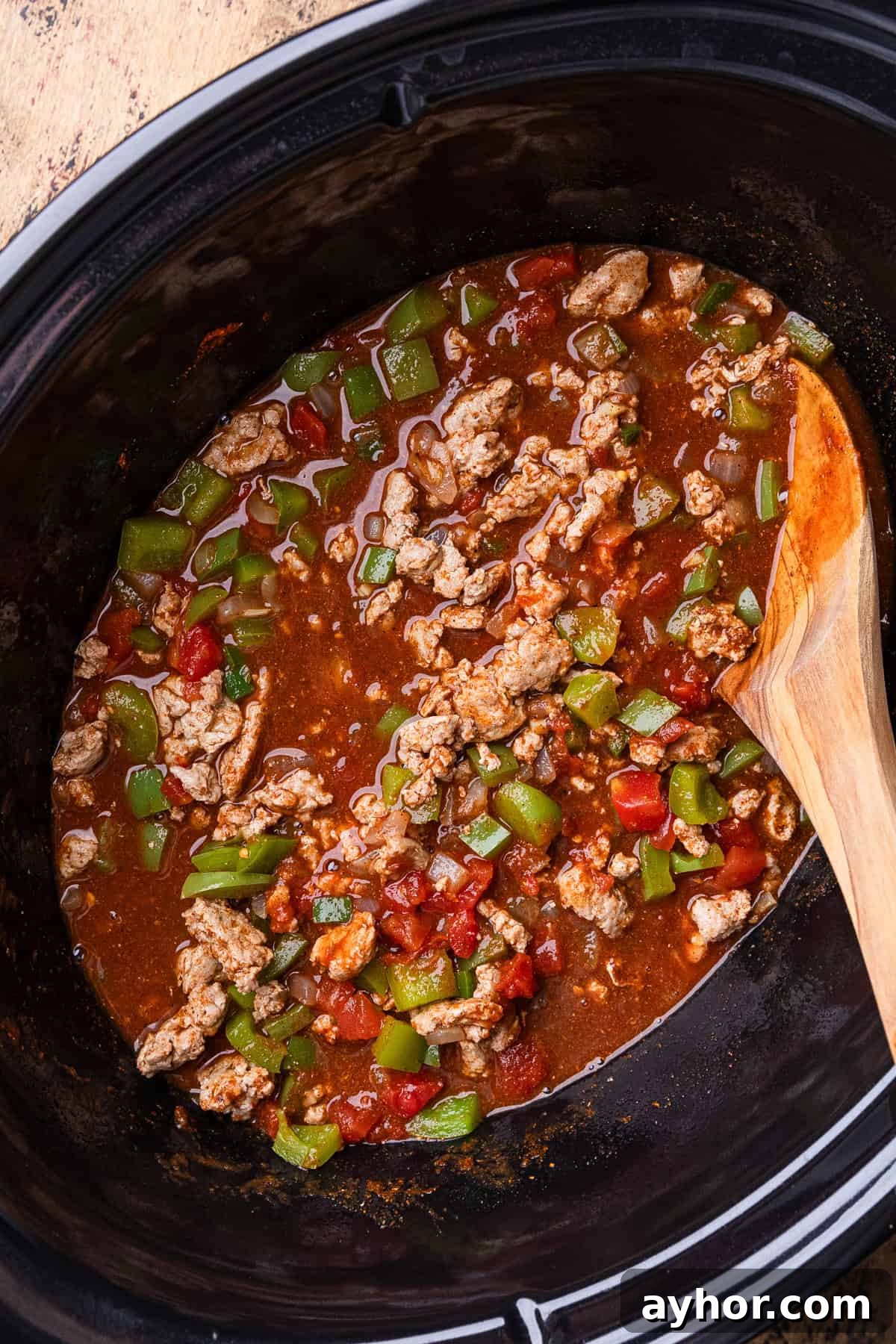 Turkey chili being stirred.