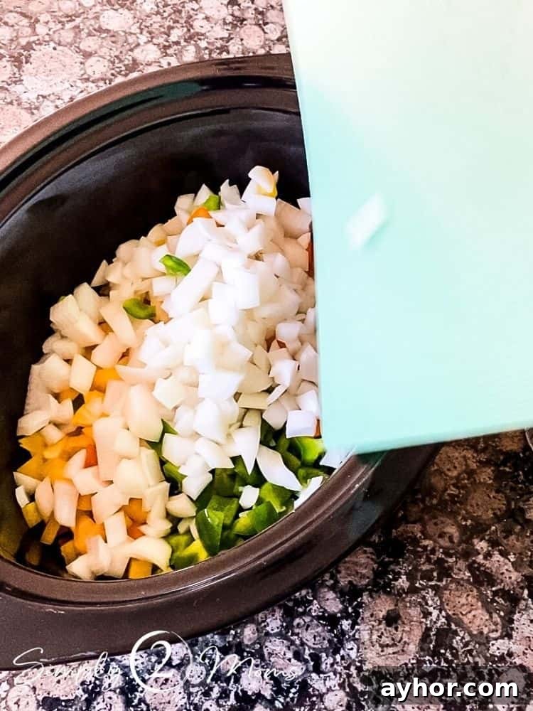 All-Meat Keto Chili Recipe (THM-S Friendly) 4 Crock pot insert filled with diced peppers and onions