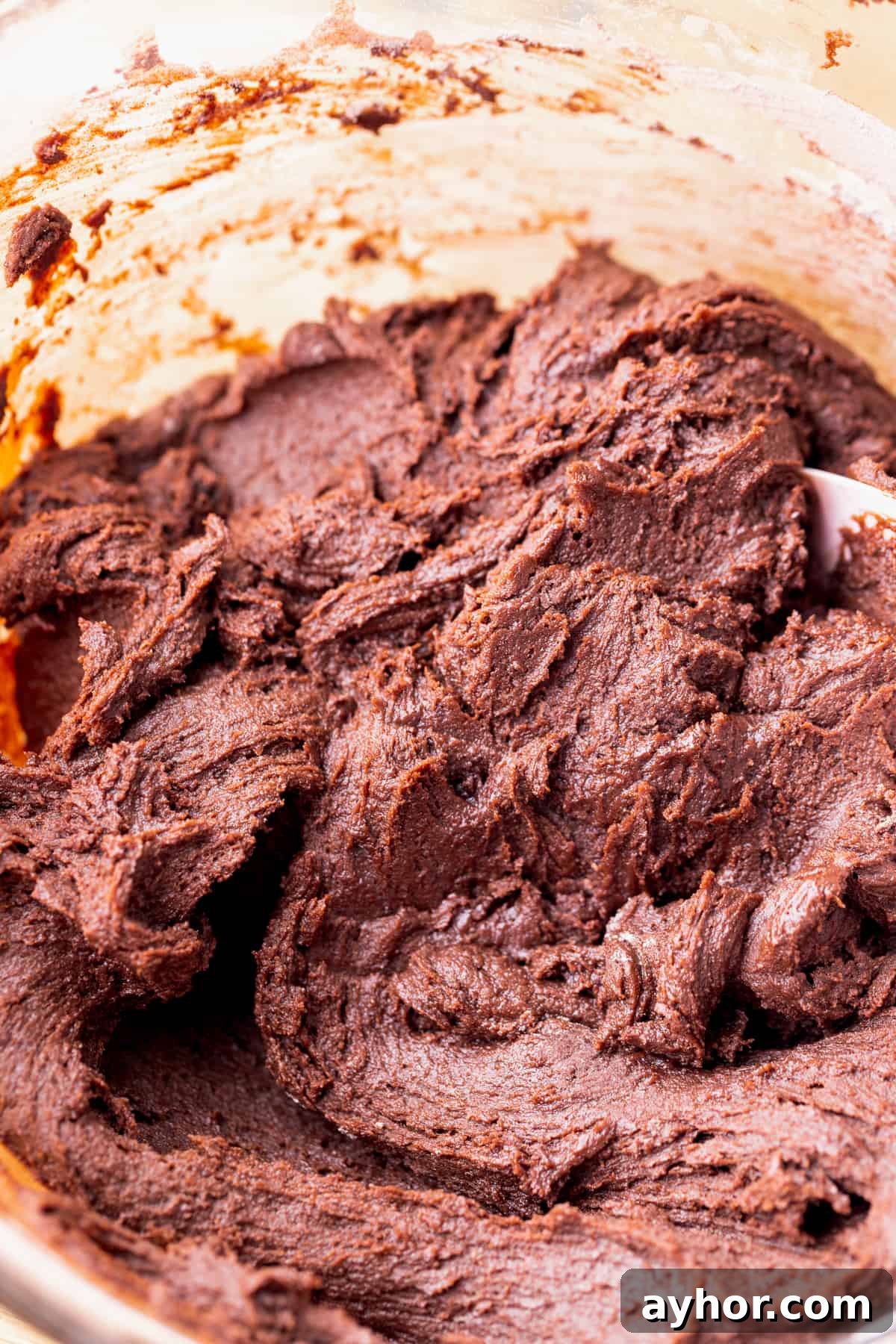 Chocolate cookie dough in a glass bowl.