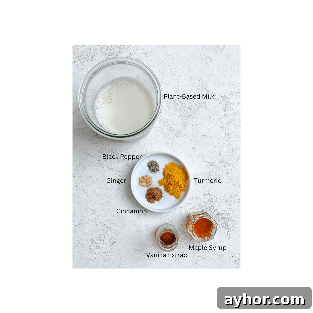 How to Make Turmeric Golden Milk: Creamy Anti-Inflammatory Latte 3 ingredients for Golden Milk measured out against a white surface