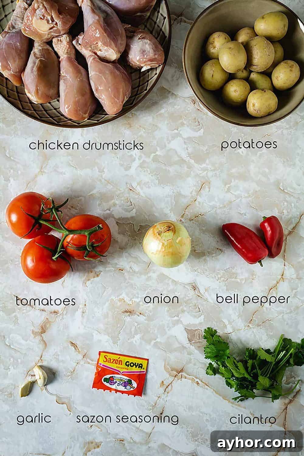 Ingredients for Sudado de Pollo with chicken drumsticks, potatoes, tomatoes, and seasonings.