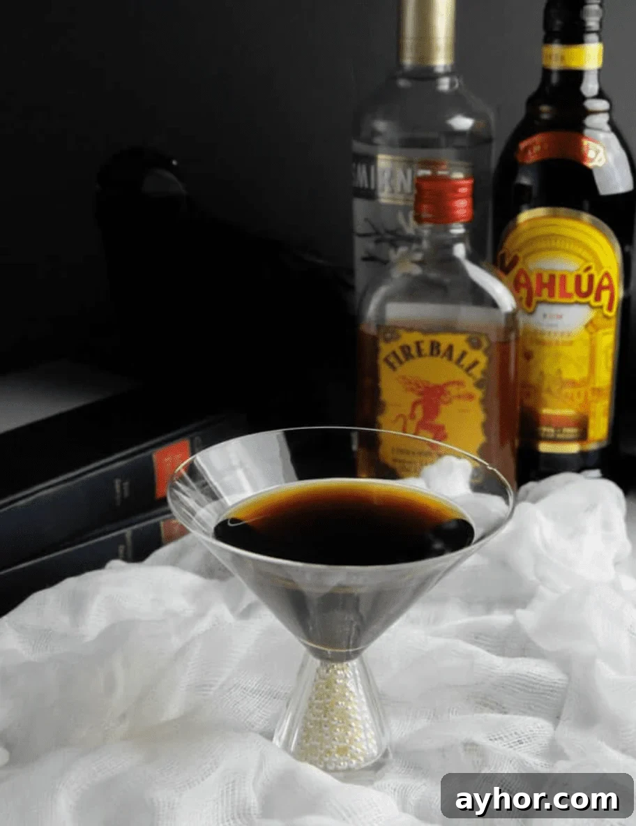 20+ Spooky Halloween Cocktail Recipes for Adults 17 Coffee inspired cocktail with liquor bottles on a table with cloth.