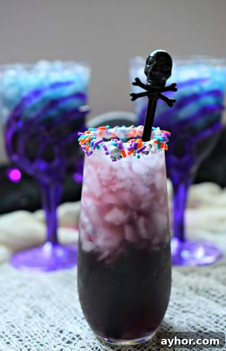 20+ Spooky Halloween Cocktail Recipes for Adults 20 Purple cocktail for halloween with sprinkles.