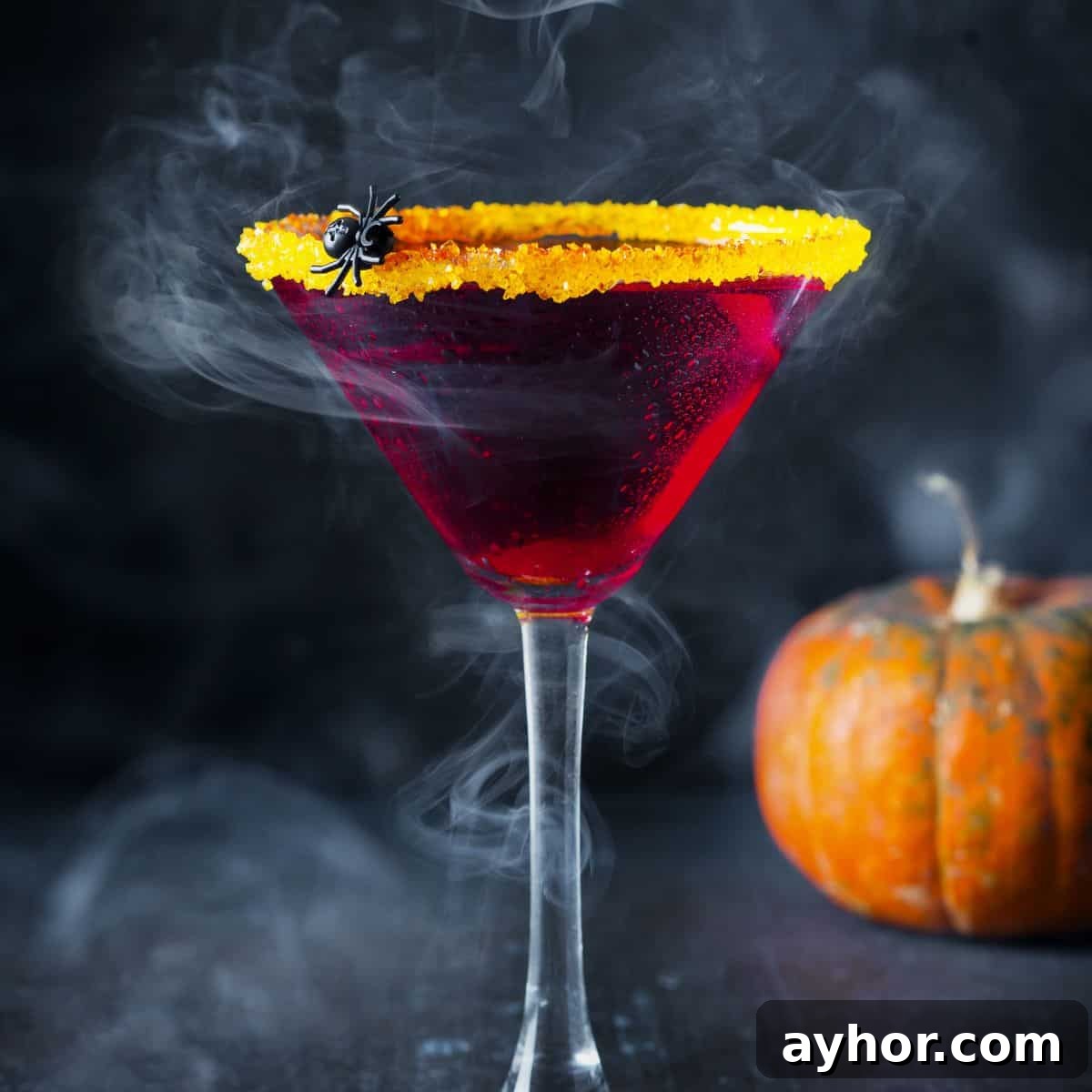 20+ Spooky Halloween Cocktail Recipes for Adults 25 Halloween cocktail with orange rim and spider.