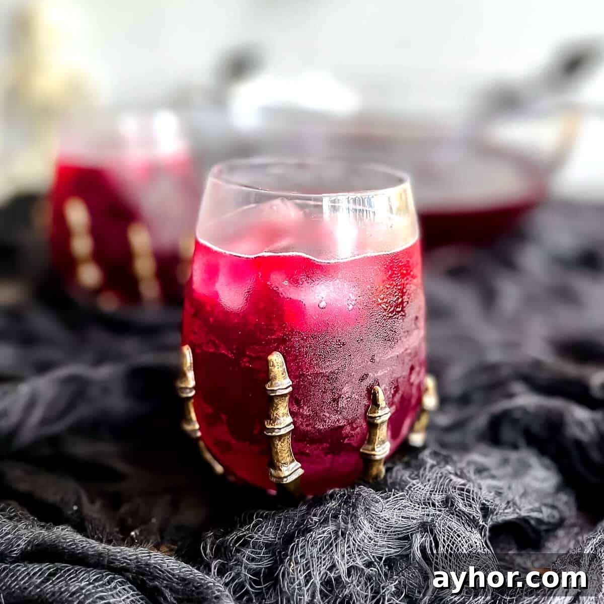 20+ Spooky Halloween Cocktail Recipes for Adults 8 Halloween punch recipe in glass.