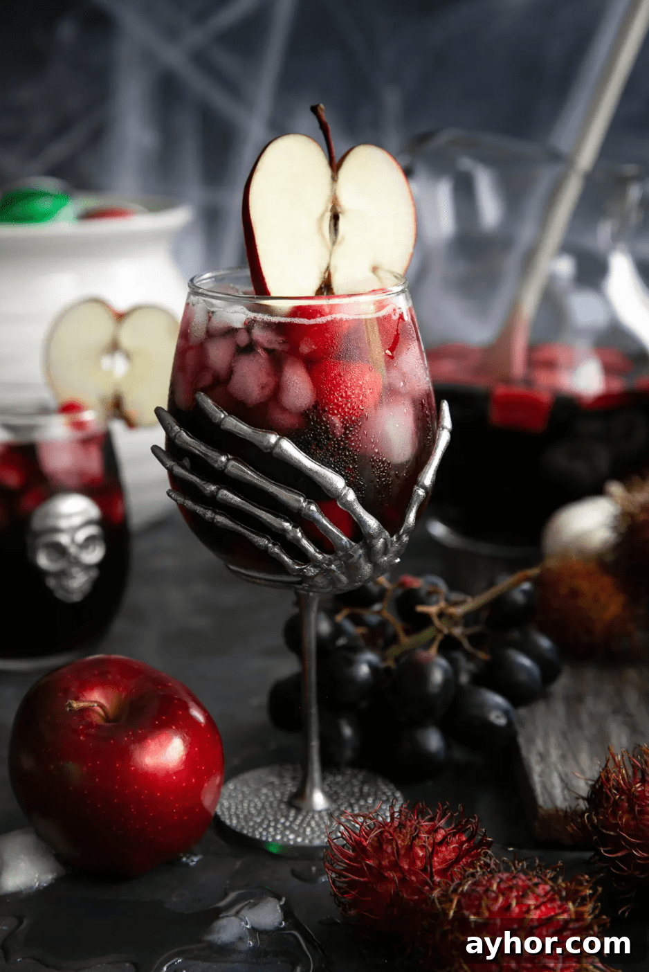 20+ Spooky Halloween Cocktail Recipes for Adults 10 Black magic halloween sangria with apple and fruit.