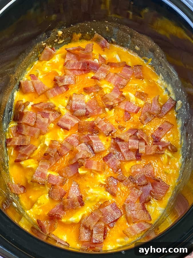 Slow Cooker Chicken with Bacon and Ranch Flavor 3 Thick layer of cheese and bacon on cheesy ranch and cream cheese chicken