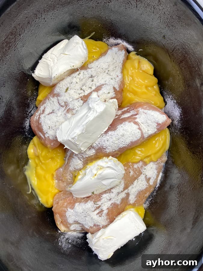 Slow Cooker Chicken with Bacon and Ranch Flavor 7 Cream cheese added to chicken and ranch in slow cooker.