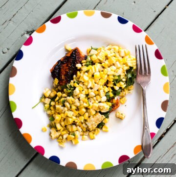 Grilled Salmon with Tomato-Caper Vinaigrette Recipe 3 Salmon topped with corn salsa on a white plate.