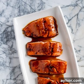 Grilled Salmon with Tomato-Caper Vinaigrette Recipe 4 Glazed salmon on a white platter.