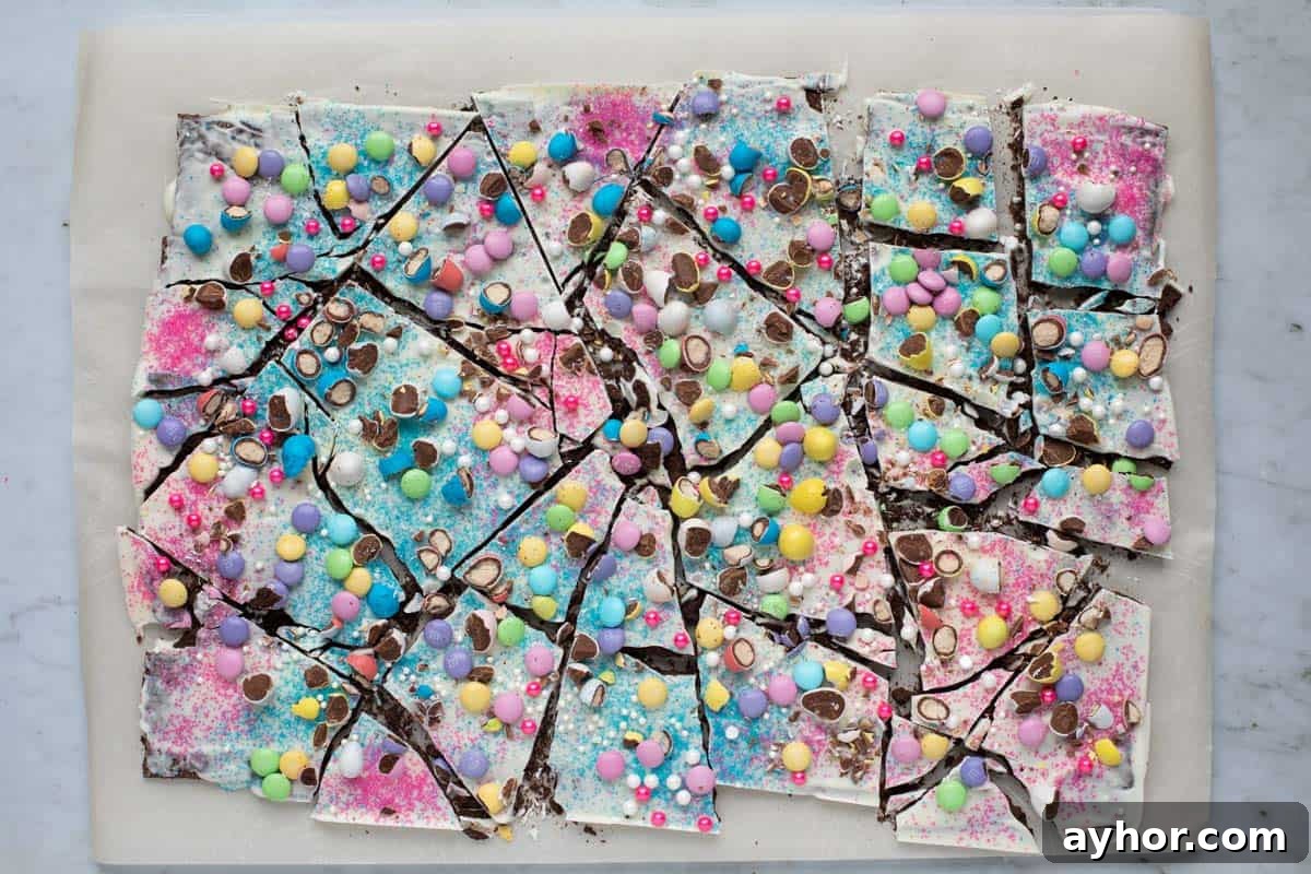 Easter Chocolate Bark Recipe: Spring Candy with Colorful Eggs 9 easter bark broken into several pieces on a parchment paper