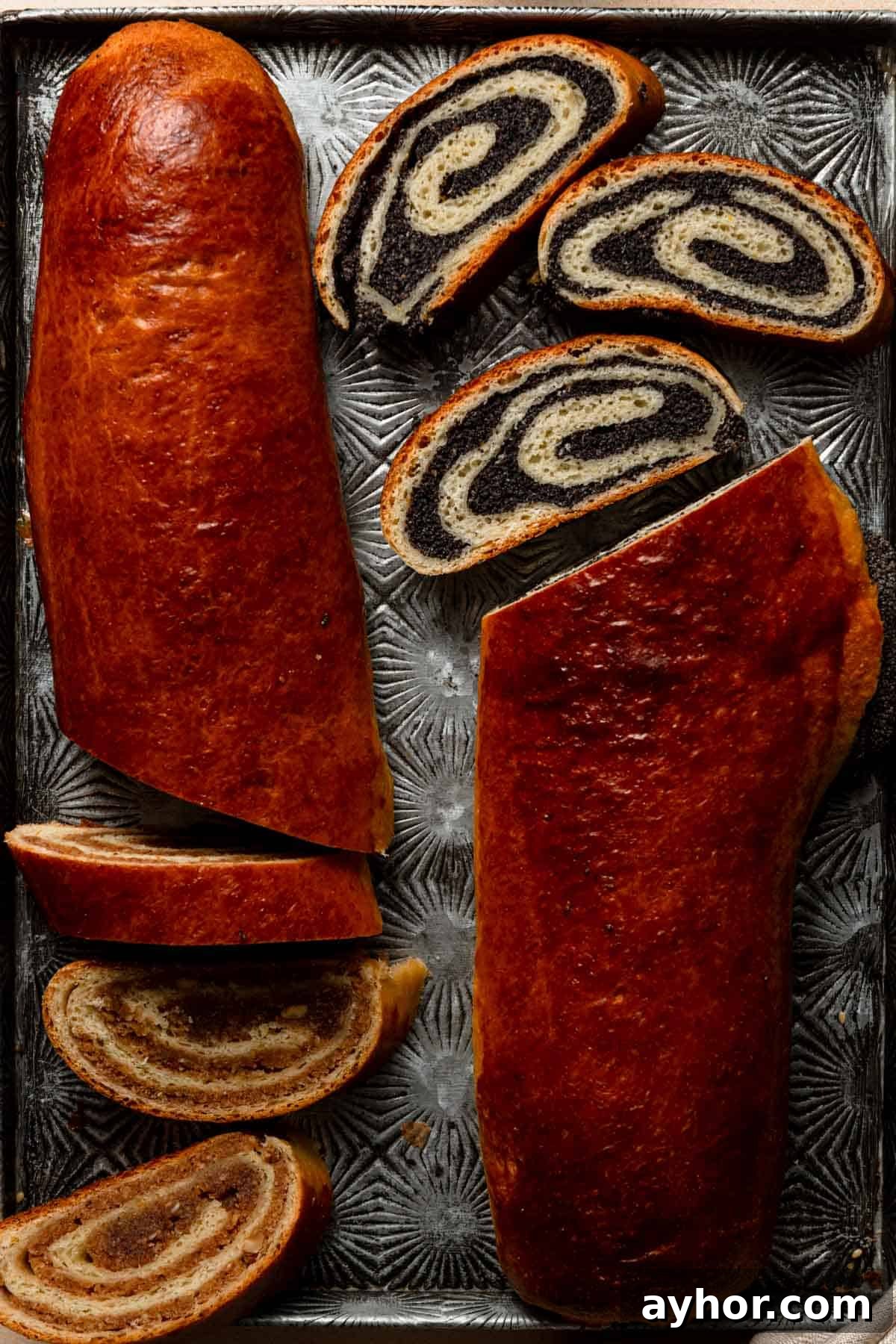 Walnut and poppy seeds beigli on a tray.