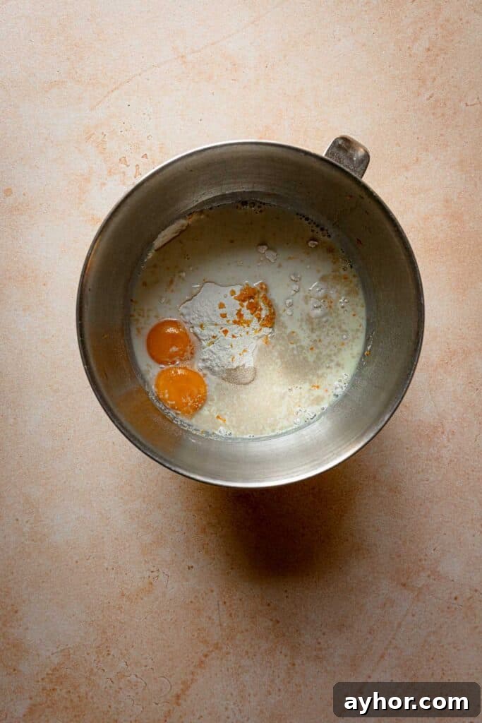 A bowl with flour, milk and eggs.