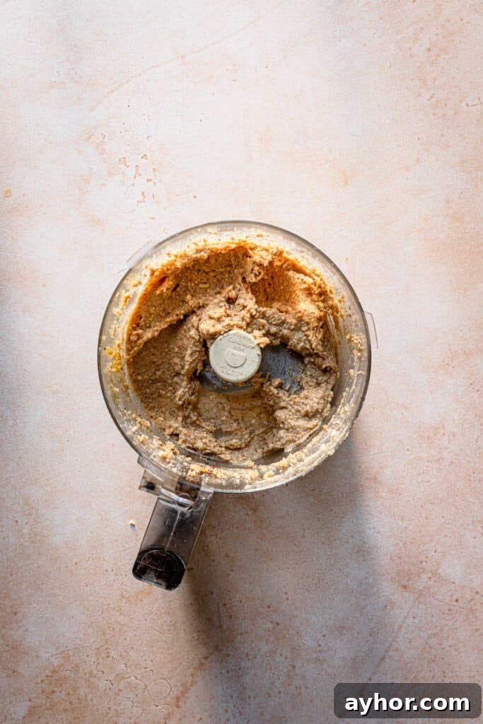 A food processor bowl with walnut filling.