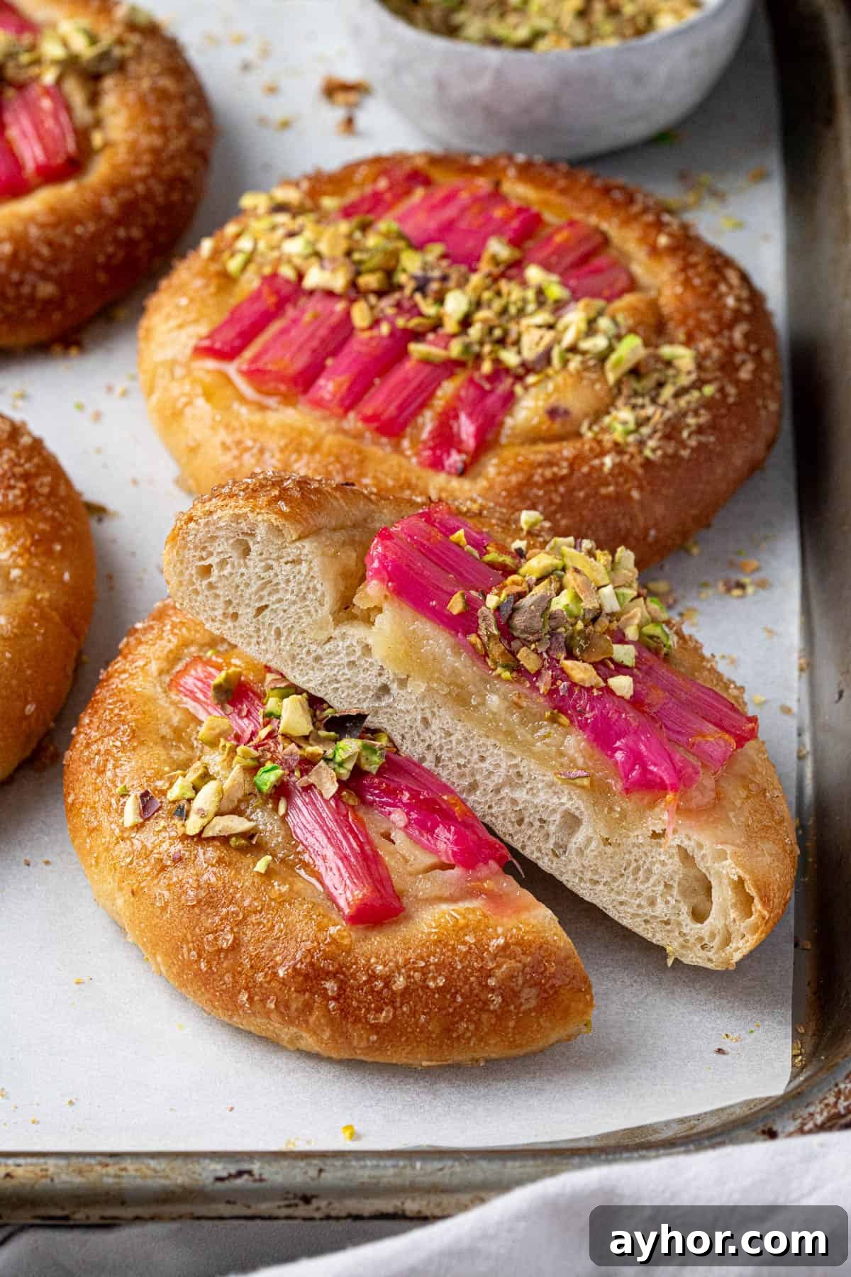 Vegan Rhubarb Frangipane Buns Recipe: Flaky Pastries with Almond Filling 4 Close up of a sliced rhubarb frangipane bun.