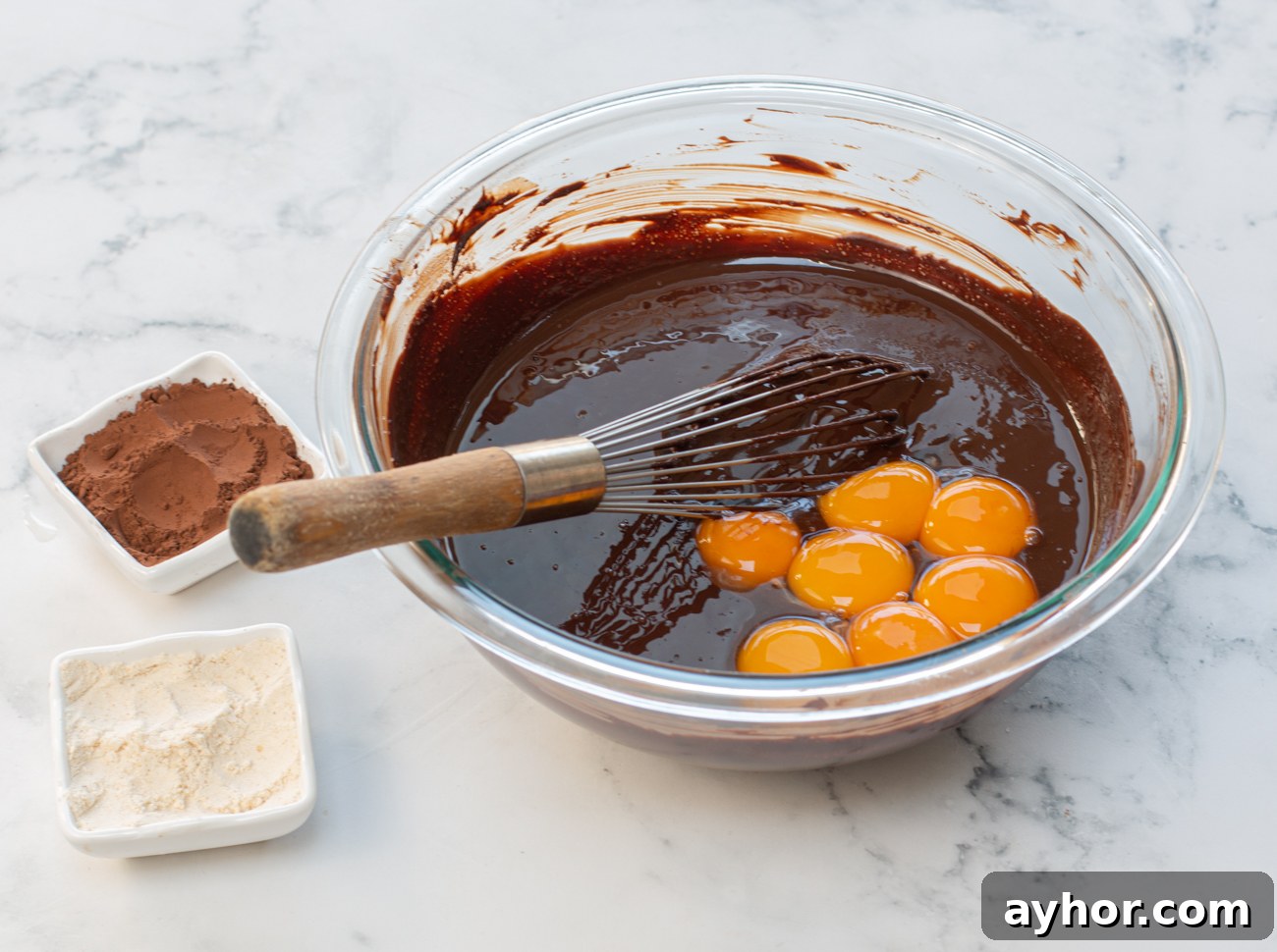 Add egg yolks to chocolate and butter mixture