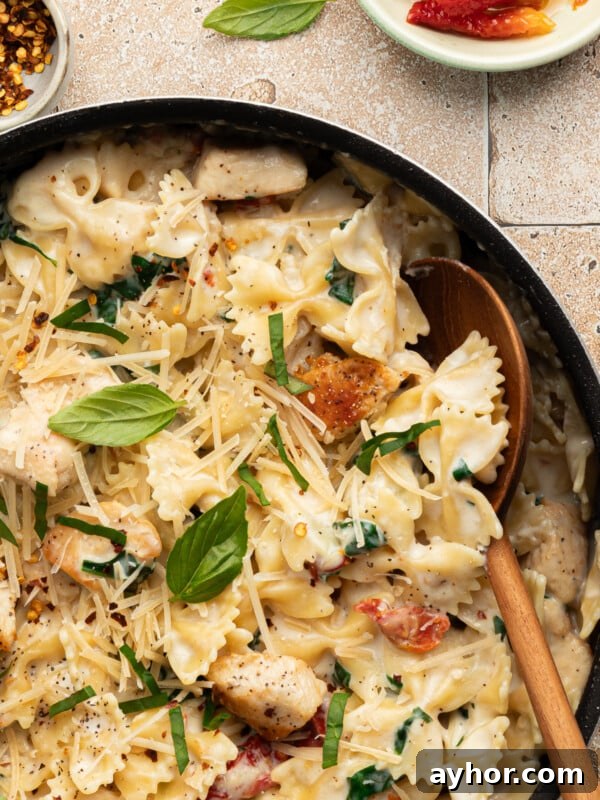 High-Protein Baked Ziti Recipe for Muscle & Meal Prep 12 Marry me chicken pasta in a pan garnished with basil.
