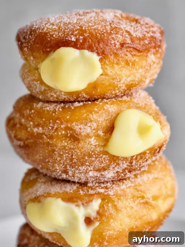 Classic Italian Panettone Recipe: Authentic Holiday Sweet Bread 24 Bomboloni stacked on a plate.