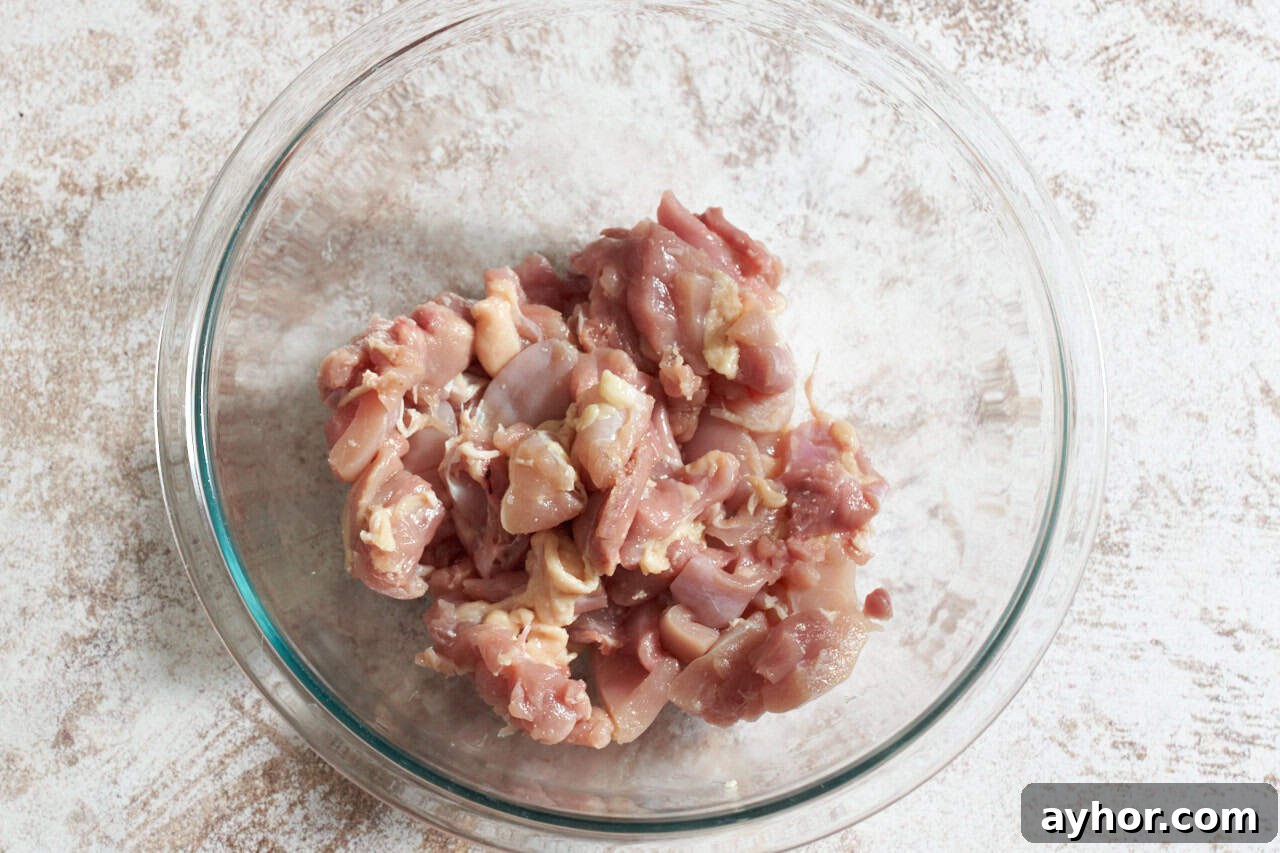 Chopped chicken thighs in a mixing bowl.