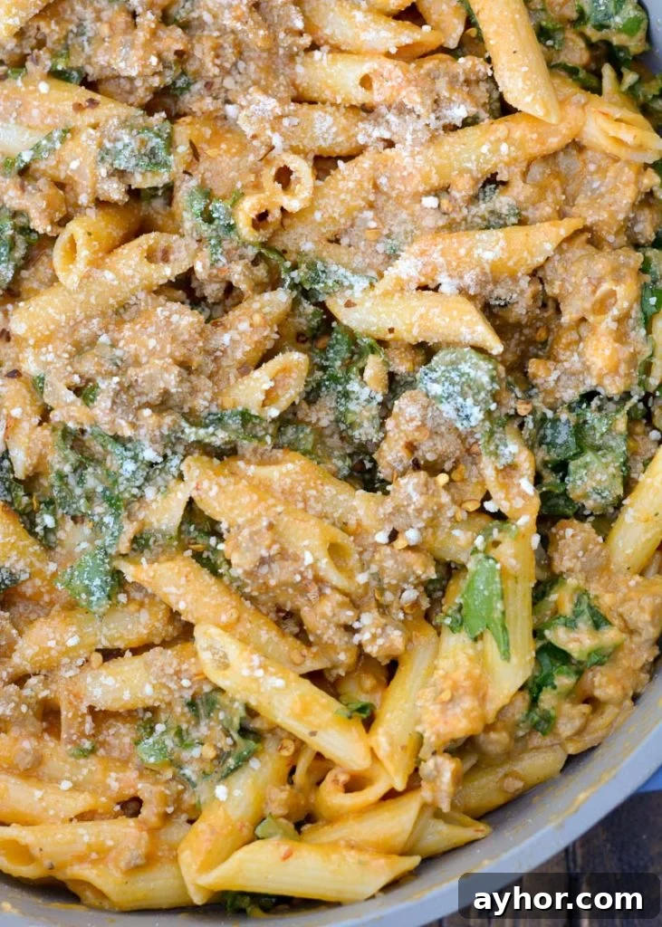 This Sausage and Butternut Squash Pasta features a creamy, lightened up pasta sauce, fresh kale and browned Italian sausage. This is the perfect family friendly dinner recipe that is ready in about 30 minutes! 