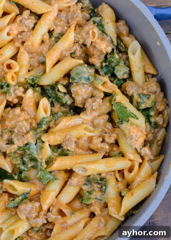 This Sausage and Butternut Squash Pasta features a creamy, lightened up pasta sauce, fresh kale and browned Italian sausage. This is the perfect family friendly dinner recipe that is ready in about 30 minutes! 