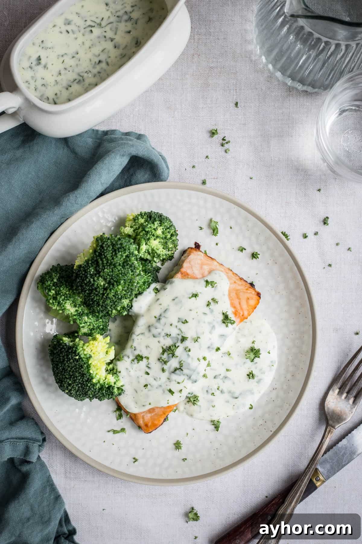 Parsley sauce drizzled over salmon and broccoli on a plate