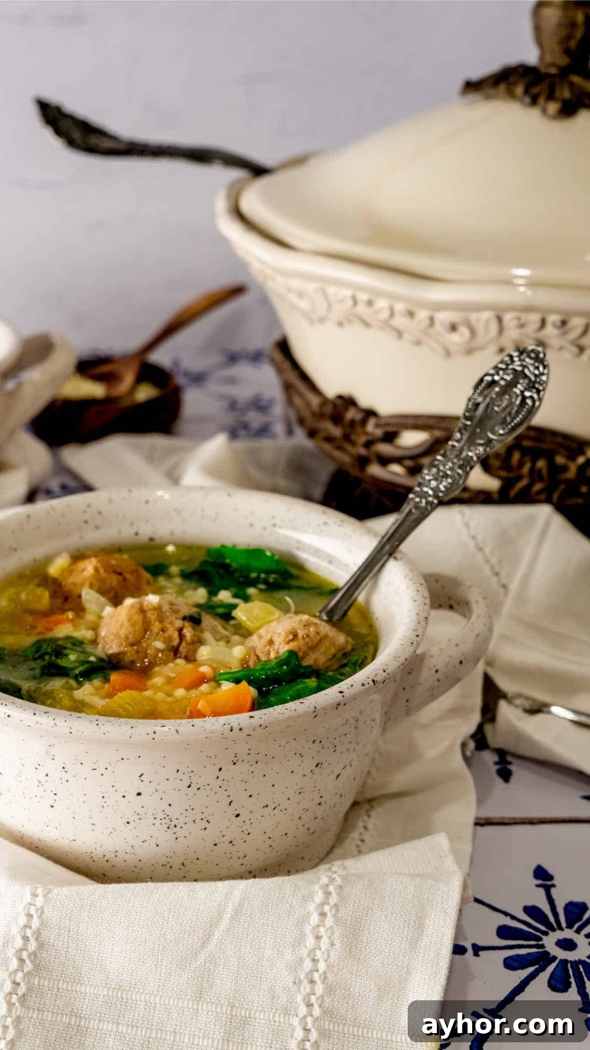 Instant Pot Italian Wedding Soup Recipe — Quick Family-Style Meal 4 Instant Pot Italian Wedding Soup with a spoon on a white linen.
