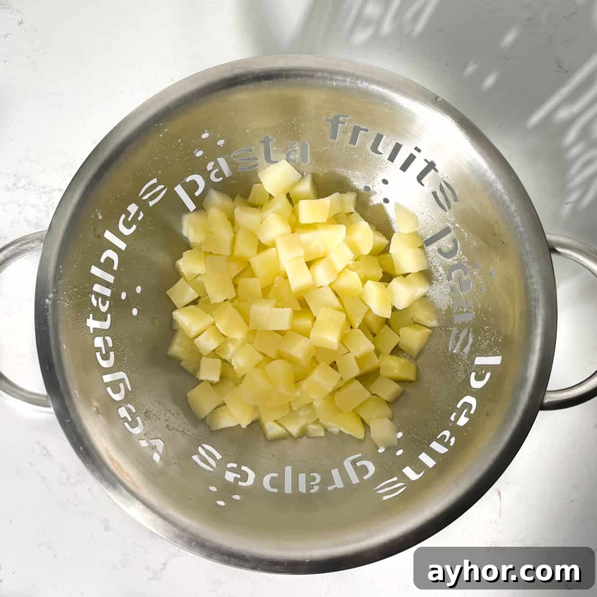 Potatoes draining in a colander.