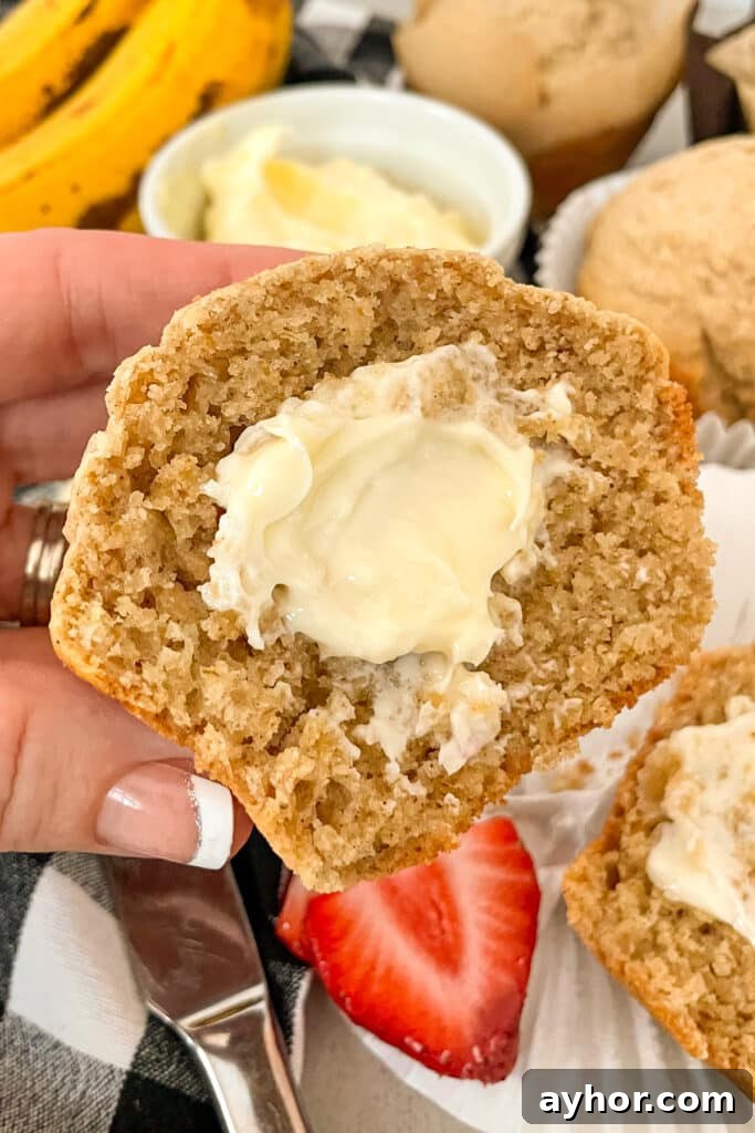 Moist Oat Bran Muffins Recipe for Fiber-Rich Breakfast 2 Close up shot of a Bran muffin that has been cut in half to show texture and smeared with softened butter.