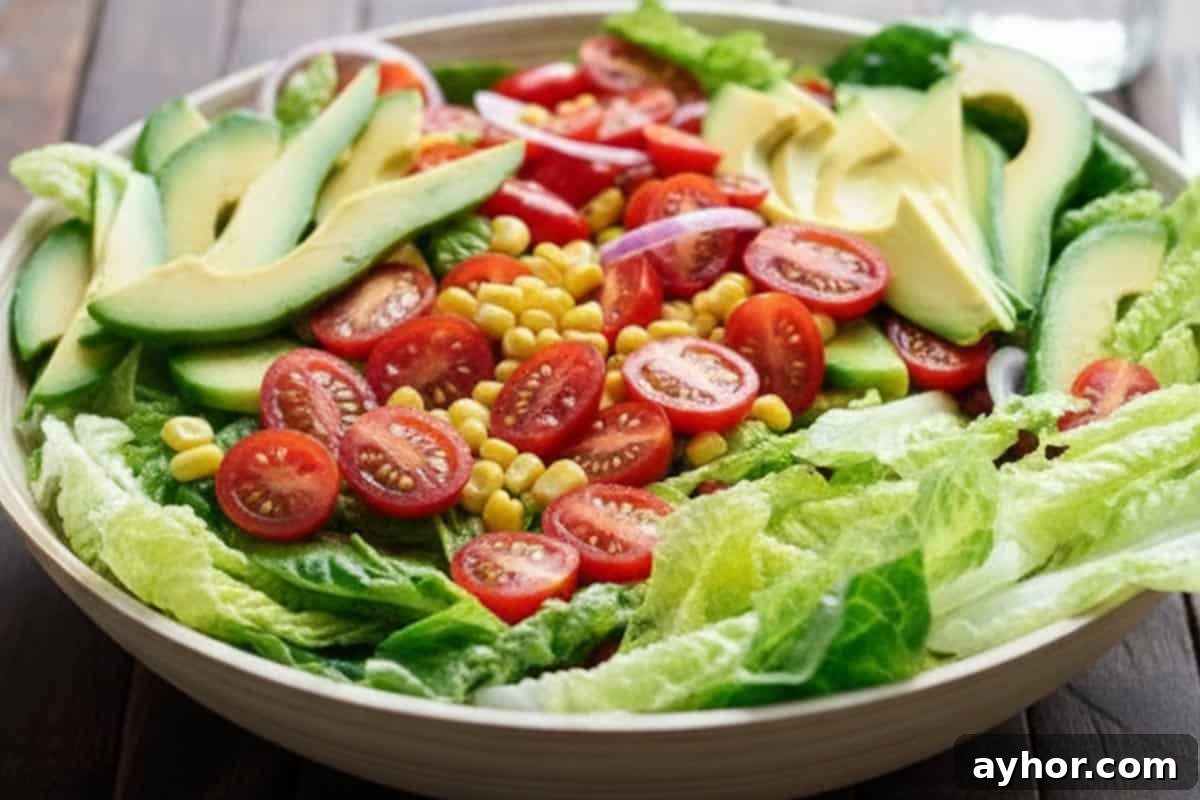 Arranged the veggies in a platter: romaine, tomatoes, avocado, corn, and onion.