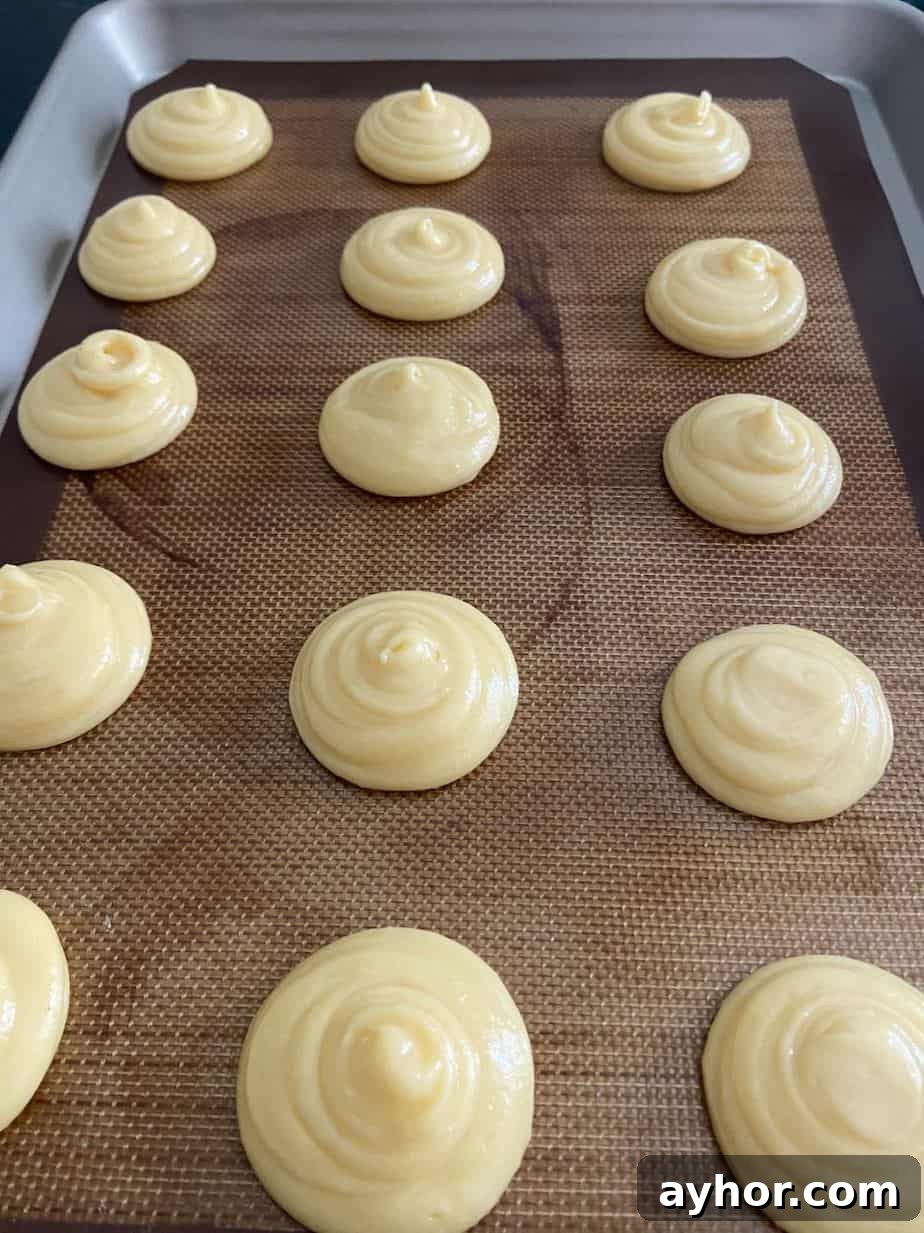 Classic Cream Puff Recipe: Homemade Choux Pastry Dessert 5 Cream puff choux pastry on baking sheet.