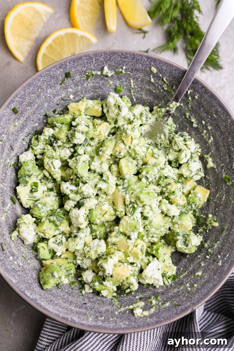 Baked Salmon with Creamy Avocado and Feta Crumble 6 A small bowl filled with diced avocado, crumbled feta cheese, lemon, fresh dill and chives