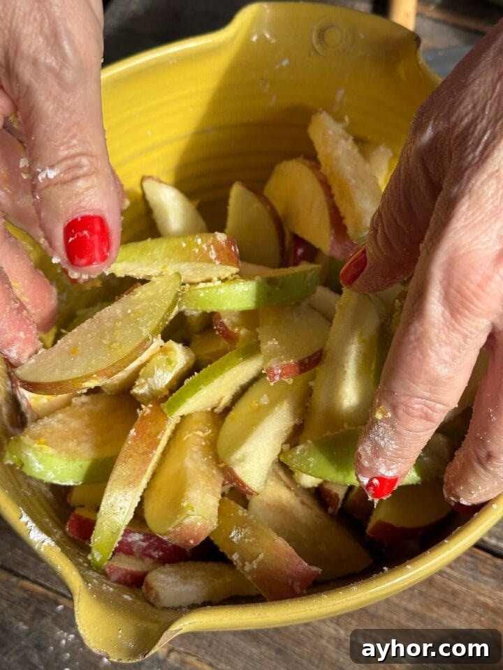Gluten-Free Apple Crumble Recipe: Crispy Topping, Tender Apples 5 a photo of teri tossing apples in flour