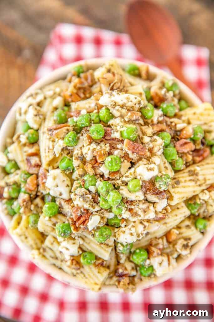 bowl of pasta salad with peas and pesto