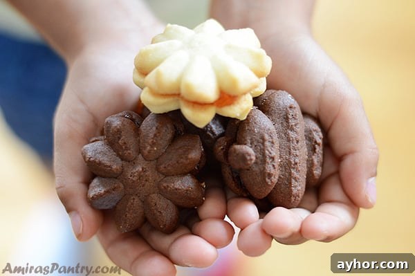 A photo of hands holding up betefour dessert cookies