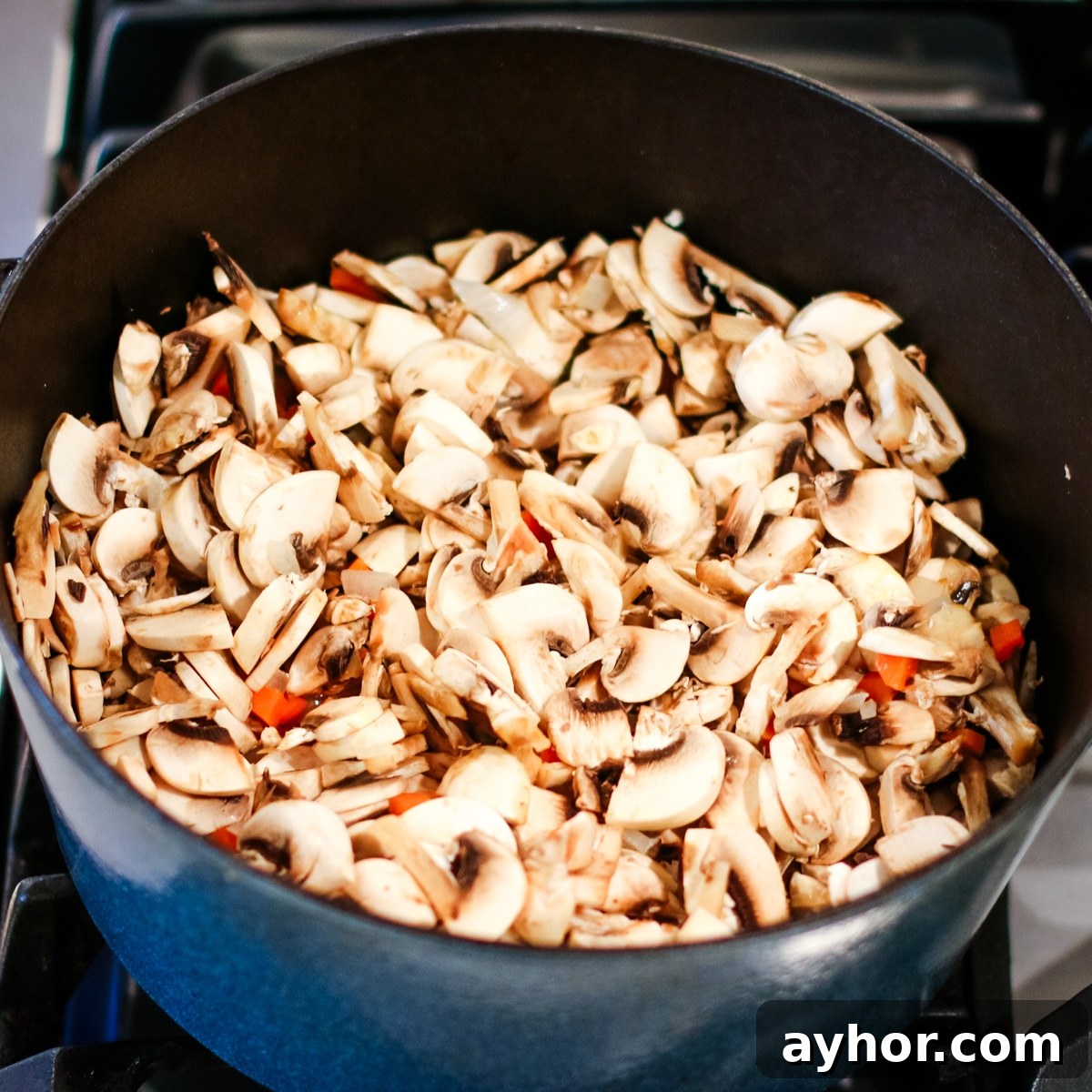 Mushroom, Rice & Turkey Soup from Leftover Roast 8 Diced mushrooms and carrots in a pot.