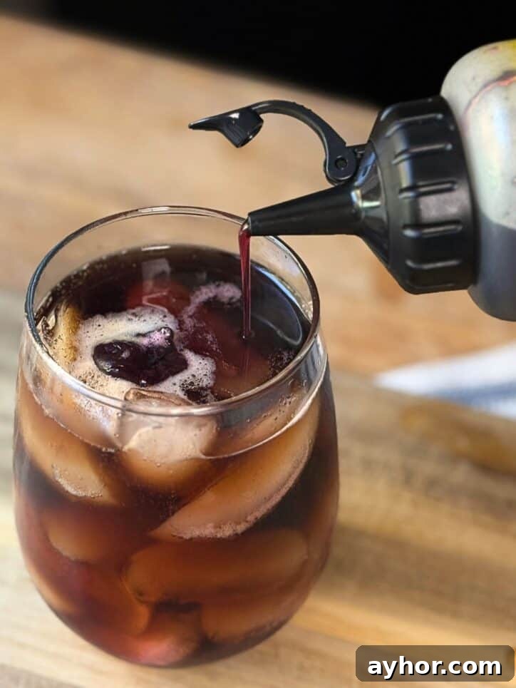 Cherry Vanilla Syrup Recipe for Homemade Drinks & Desserts 4 Coke with Cherry Vanilla Syrup being added