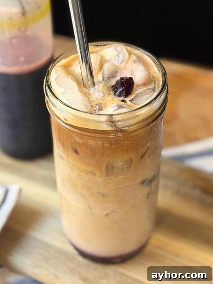 Cherry Vanilla Syrup Recipe for Homemade Drinks & Desserts 5 Iced coffee with Cherry Vanilla Syrup and a cherry on top