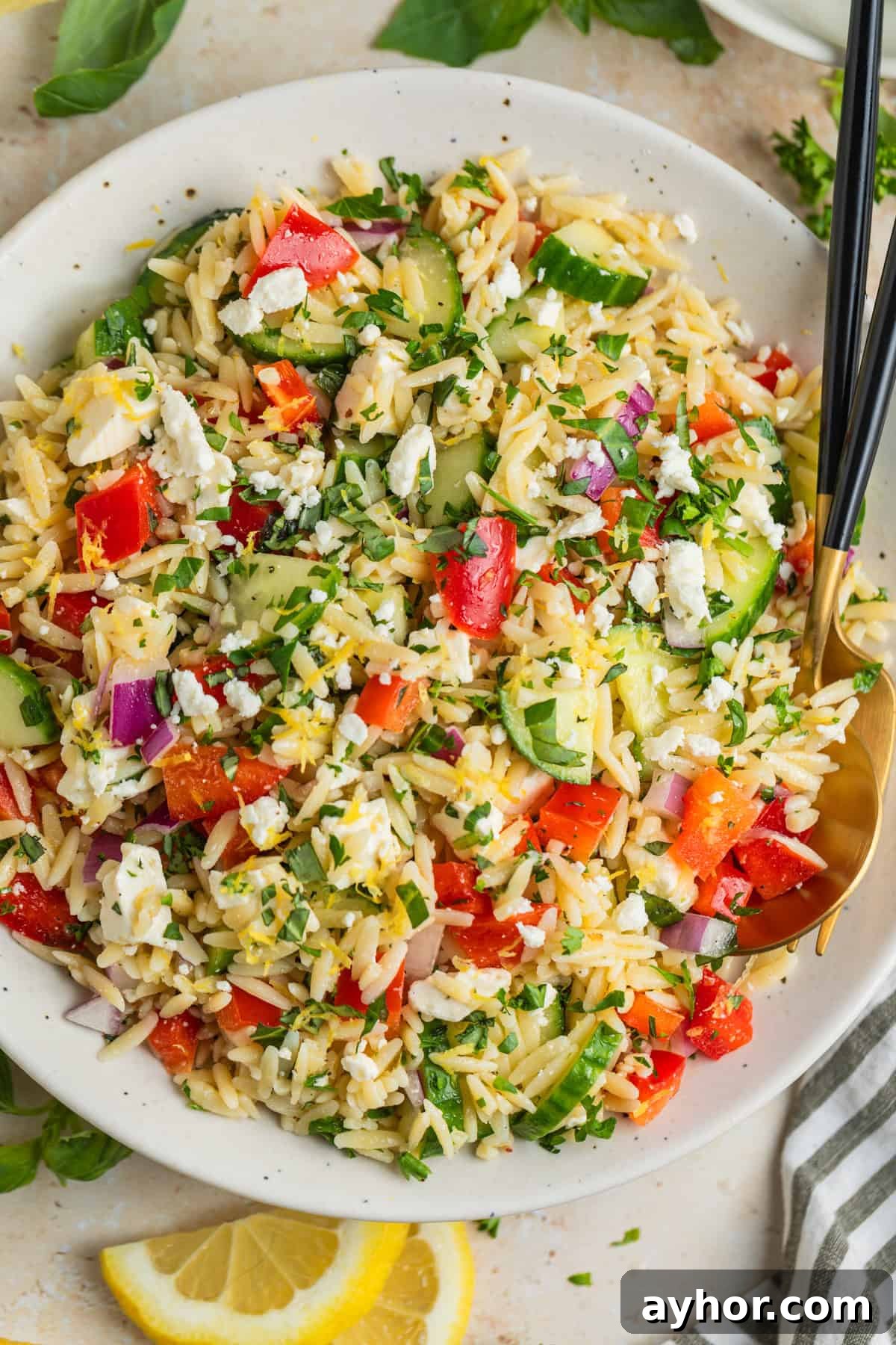 Overhead view of lemon orzo salad with fresh parsley and feta.