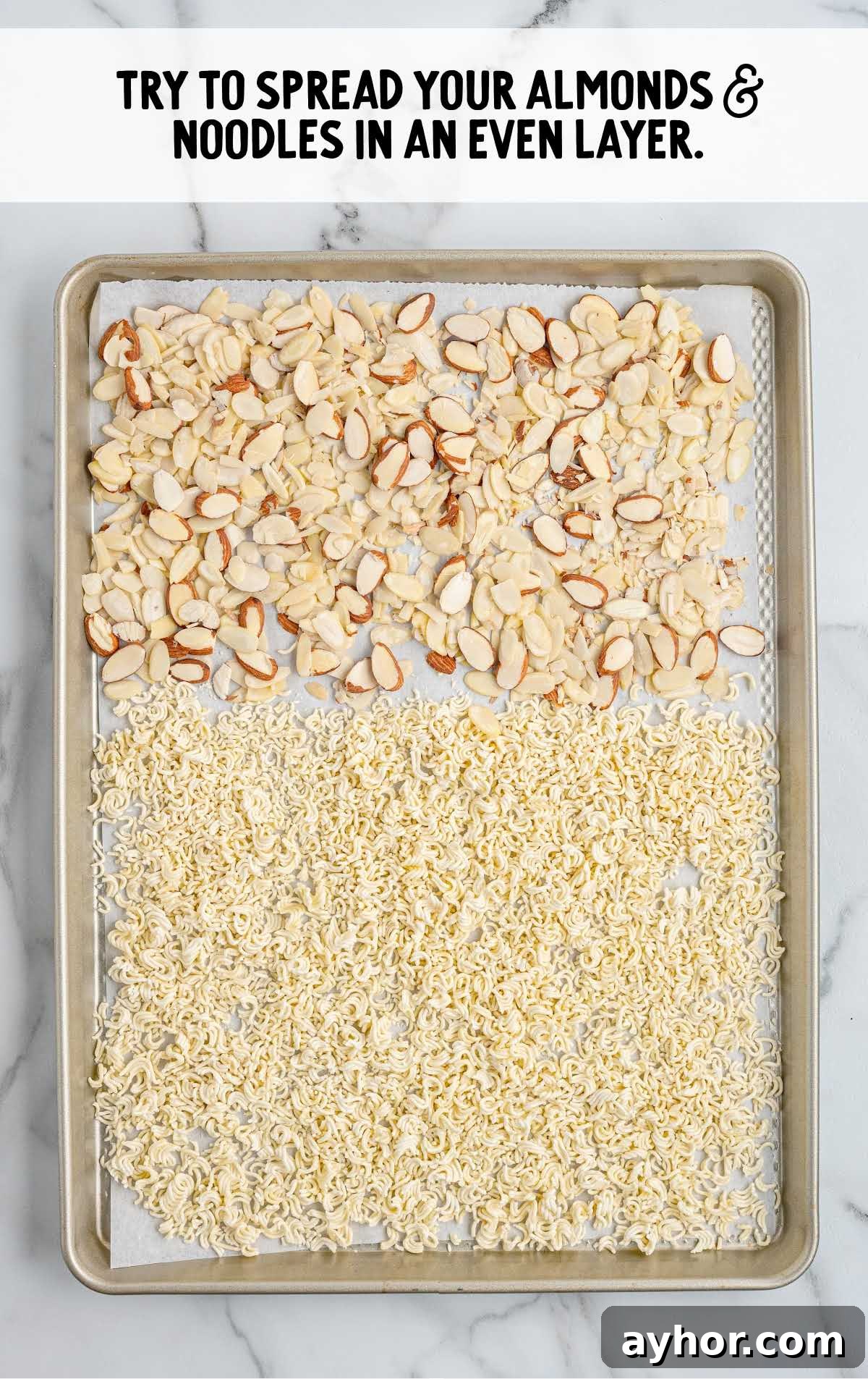 Crunchy Japanese Ramen Noodle Salad with Sesame-Ginger Dressing 4 Sheet pan with toasted ramen noodles and sliced almonds spread evenly for baking
