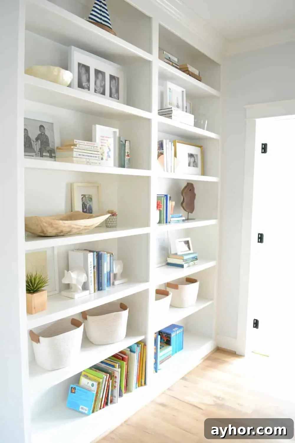 styled built in bookcases in a hall