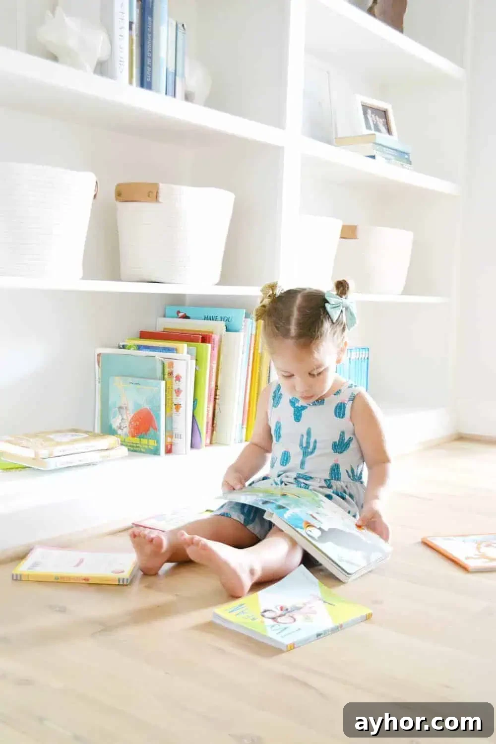 a little girl showing how she styles built In bookcases